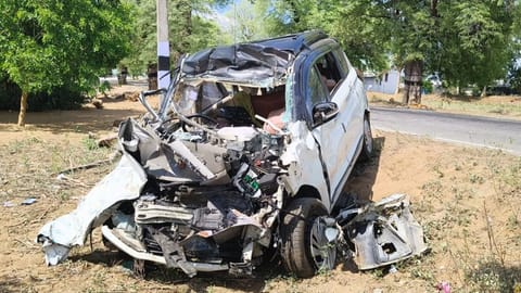 The mangled remains of the car involved in head on collision with a lorry at Thuraiyur in Tiruchy on Tuesday