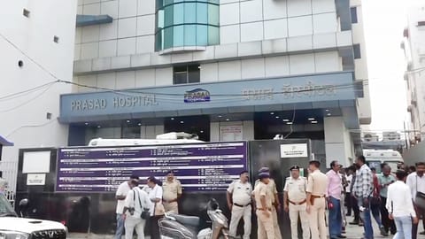Police personnel and others gather outside a hospital after a fire in its ICU killed at least three people, in Muzaffarpur district, Bihar, Thursday, June 4, 2026