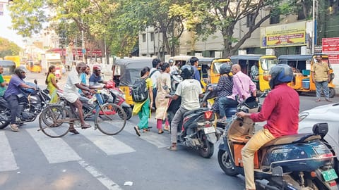 Motorists jump signal while pedetrians cross Old Jail Road