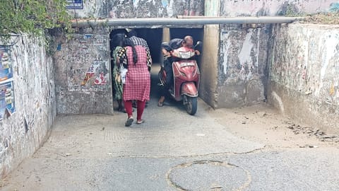 Restricted headroom forces riders to bend while passing through the culvert connecting Poleri Amman Koil Street and AA Road with Perambur High Road