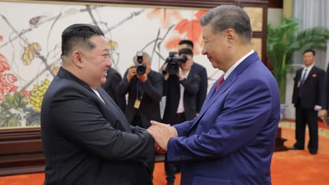 Chinese President Xi Jinping shakes hand with North Korea President Kim Jong Un
