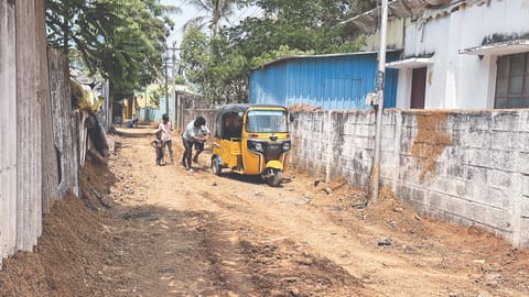 A few youngsters push the auto stuck in an uneven stretch on Gangadharan Nagar 2nd street in Puzhal
