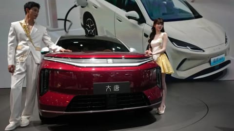 Models standing next to Chinese automaker BYD showcased at the Auto China 2026 in Beijing