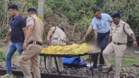 Police and railway officials recover bodies from the railway tracks after three women and a boy were killed after allegedly jumping off the Khajuraho-Udaipur Intercity Express following rumours of a fire on board