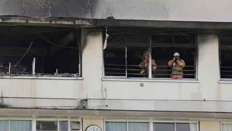 Firefighters work at the site of a fire at an elementary school in Tokyo