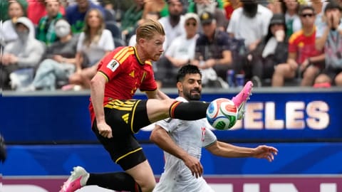 Belgium's Kevin De Bruyne, front, tries control the ball past Iran's Hossein Kanani during the World Cup Group G soccer match between Belgium and Iran in Inglewood, Calif., near Los Angeles