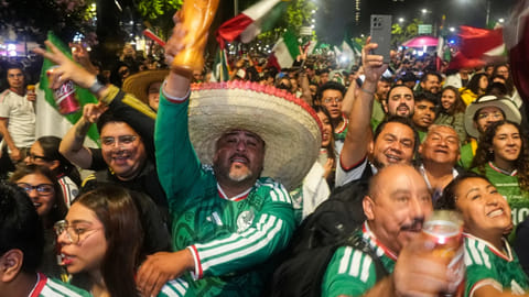 Mexican fans celebrate after beating South Korea during the World Cup Group A soccer match, at the Angel of Independence monument in Mexico City