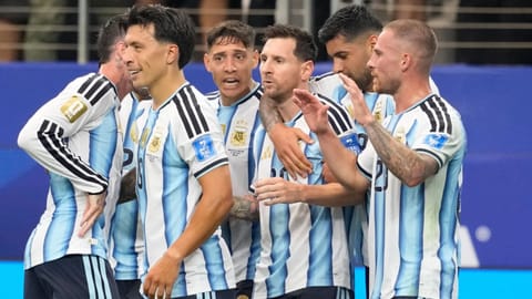 Argentina’s Lionel Messi (10) celebrates scoring his side’s first goal against Austria with teammates during the World Cup Group J soccer match in Arlington, Texas, near Dallas