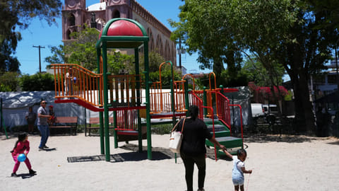 Vivianne Petit Frere walks with her granddaughter Alexca at a playground
