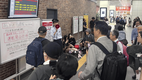 A station clerk of the East Japan Railway Co., provides an update about train services which were suspended due to an earthquake at JR Morioka station in Morioka, northern Japan