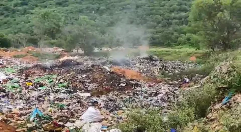 Smoke billows from the garbage dump causing air pollution