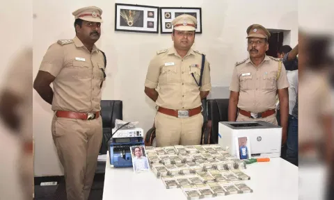 Police with the seized counterfeit notes.