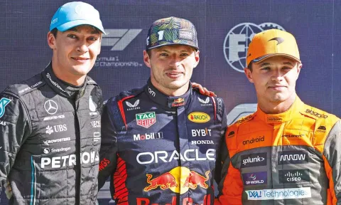 Mercedes' George Russell, Red Bull's Max Verstappen and McLaren's Lando Norris pose after taking the leading positions in the qualifying session 