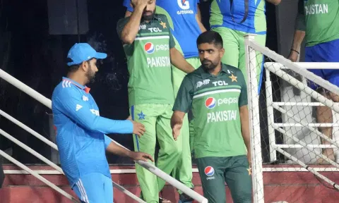 Babar Azam shakes hands with Rohit Sharma after the match was called-off