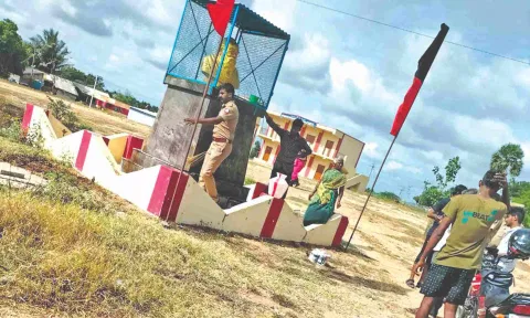 Cops washing the bust of Periyar statue smeared with cow dung in Vadachithur village near Coimbatore on Wednesday