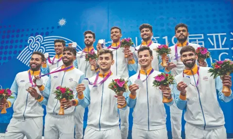 Badminton team members pose with their silver medals