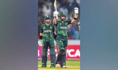 Abdullah Shafique raises his bat after scoring hundred against Sri Lanka