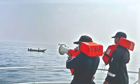 Coast Guard warning fishermen in the sea off Chennai.
