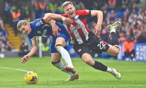 Chelsea’s Conor Gallagher (L) challenges Nathan Collins during the match