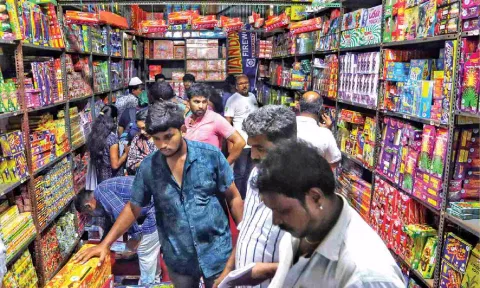 People buy crackers in Island Ground shops ahead of Deepavali