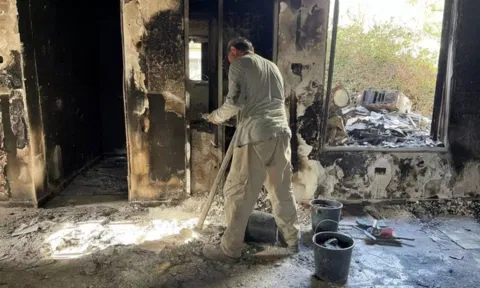 Archeologists from the Israel Antiquities Authority sift through the remains of burnt-out houses to look for human remains (Image: ANI)