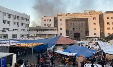 Smoke rises as displaced Palestinians take shelter at Al Shifa hospital (Image: REUTERS)