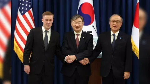 National Security Adviser Cho Tae-yong, center, shakes hands with U.S. National Security Adviser Jake Sullivan, left, and Japan's National Security Secretariat Secretary General Takeo Akiba in the press briefing room of the presidential office in Seoul