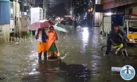 People walking through flood water. (Hemanathan M)