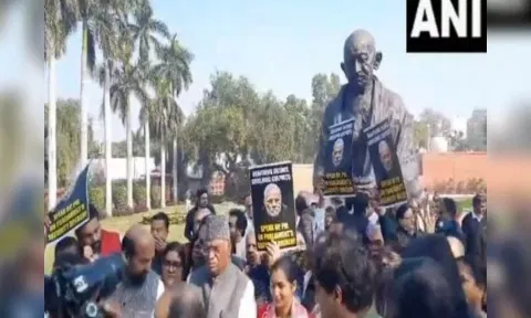 Opposition members protest suspension of 92 MPs in front of Gandhi Statue in Parliament premises (Photo: ANI)