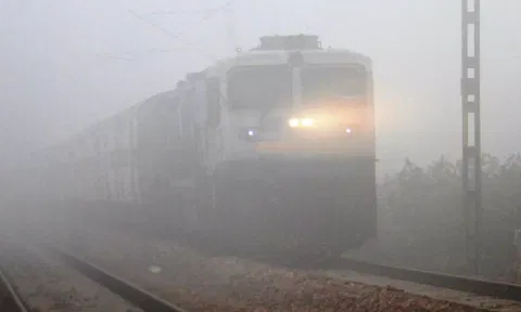 A train runs amid low visibility due to dense fog. (PTI)