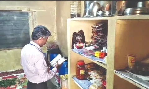 An official of the Food Safety Department inspects the college kitchen on Friday