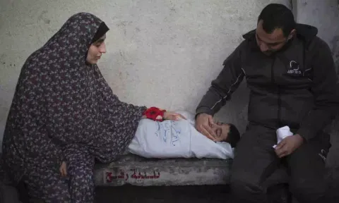 Palestinians mourn a child killed in the Israeli bombardment of the Gaza Strip at a hospital morgue in Rafah, Monday, Feb. 12, 2024. (AP)