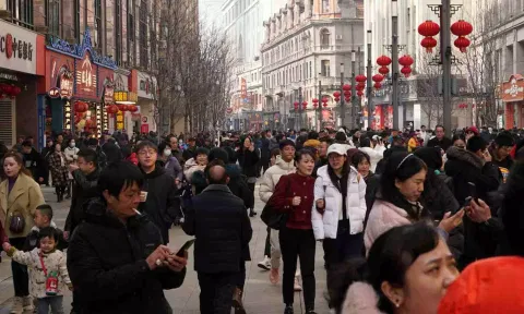  Visitors throng a pedestrian shopping street on the first day of the Lunar New Year of the Dragon (Reuters)