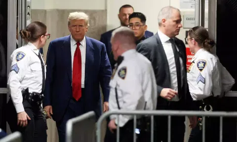 Donald Trump walks in the hallway outside a courtroom