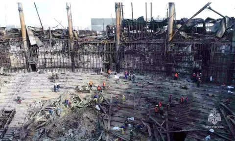 Members of the Russian Emergencies Ministry and workers remove debris inside the burnt-out Crocus City Hall. (Reuters)