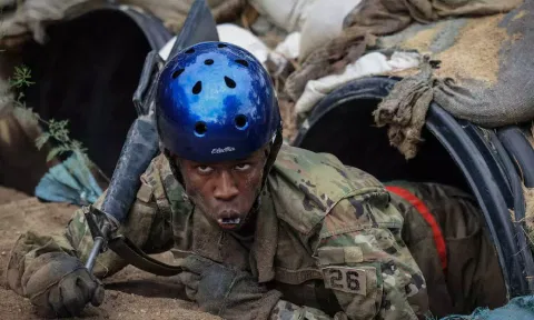 Tusajigwe Owens crawls out of a tunnel in the assault course at the U.S. Air Force Academy in Colorado Springs (Reuters) 