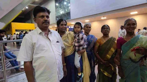 Abinaya Murugan carrying her nephew Visrith being received by their relatives at Chennai airport on Monday night