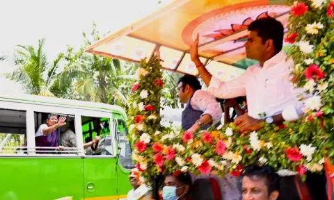 BJP state president K Annamalai waiving to a woman in a bus while campaigning for Kollam BJP candidate recently 