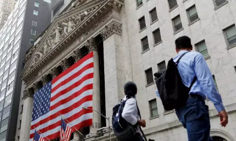 People walk by the New York Stock Exchange (NYSE) in Manhattan, New York City (REUTERS)