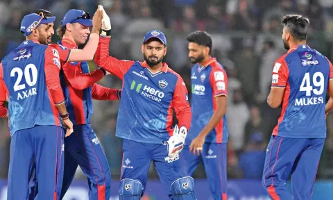 Delhi Capitals team players celebrating after a wicket 
