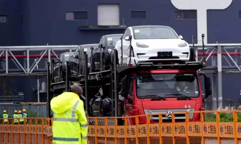  A truck transports new Tesla cars at its factory in Shanghai (Reuters)
