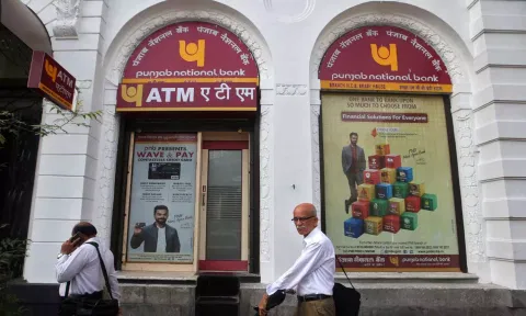 People walk past Punjab National Bank's Brady House branch in Mumbai 
