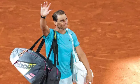 Rafael Nadal gestures to the public as he leaves the court after losing to Alexander Zverev 