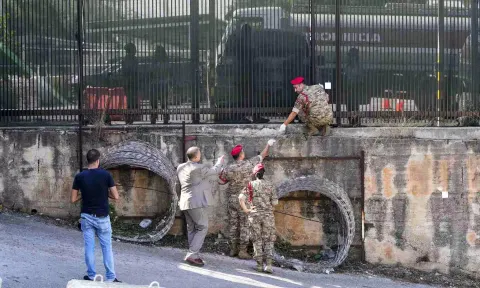 
Lebanese Army investigators inspect bullet holes and collect forensic evidence next to the entrance of U.S. Embassy in Aukar (Photo/AP)