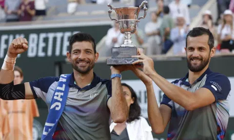 Marcelo Arevalo, of El Salvador, and Mate Pavic of Croatia celebrate with the trophy as they won the men's doubles final match of the French Open tennis tournament 