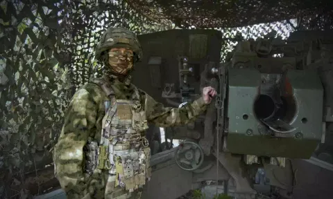 A Russian soldier poses for a photo next to a 2A65 "Msta-B" howitzer at a position in an undisclosed location in Ukraine. (AP)