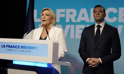 French far-right leader Marine Le Pen delivers a speech as Jordan Bardella, president of the French far-right National Rally 
