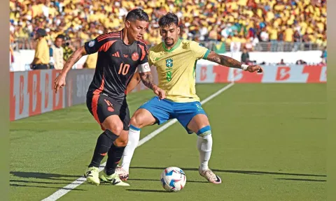 Colombia's James Rodriguez and Brazil's Lucas Paqueta vie for the ball