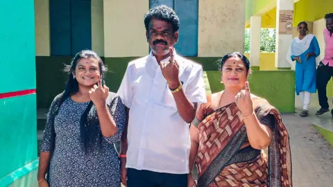 MLA C Sivakumar and family members show inked fingers at a polling station at Tiruvamathur on Wednesday
