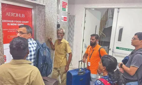 Passengers in front of one of the lifts at the multi-level car parking